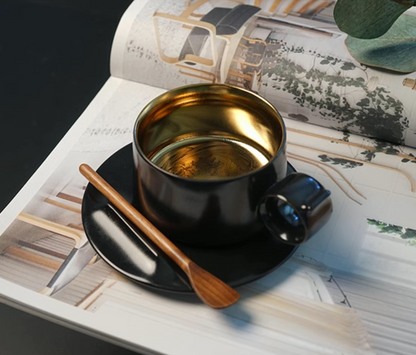 Starry Black Gold ceramic coffee mug with saucer on magazine setting, featuring ring handle and gold interior with Iris flower engraving