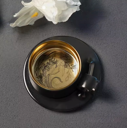 Starry Black Gold titanium ceramic coffee mug with saucer, top view showing gold interior with Iris flower engraving detail
