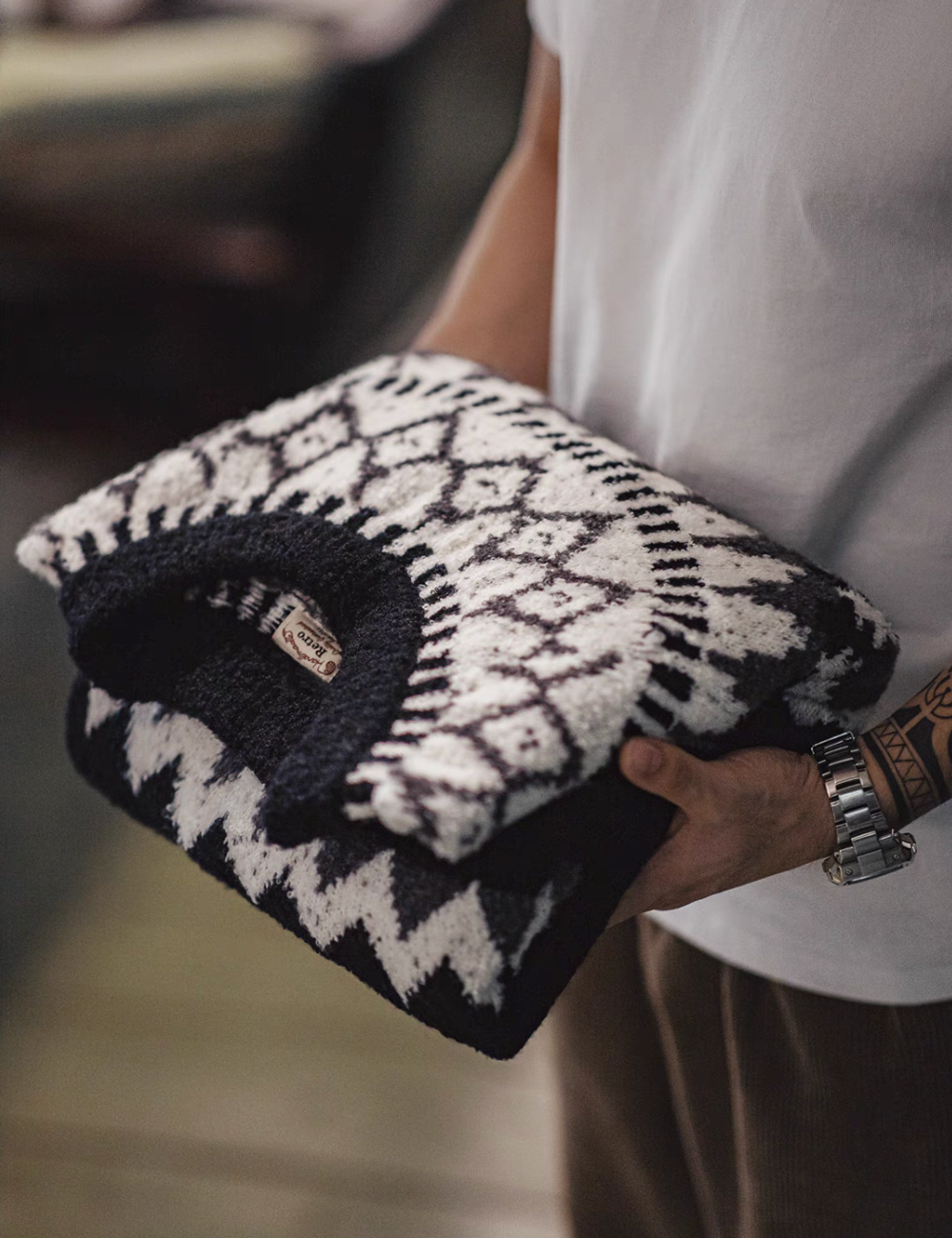 Glacier Peaks Knit Sweater in Black White Gray folded display showing bold Icelandic geometric pattern textured knit fabric and thick cozy construction