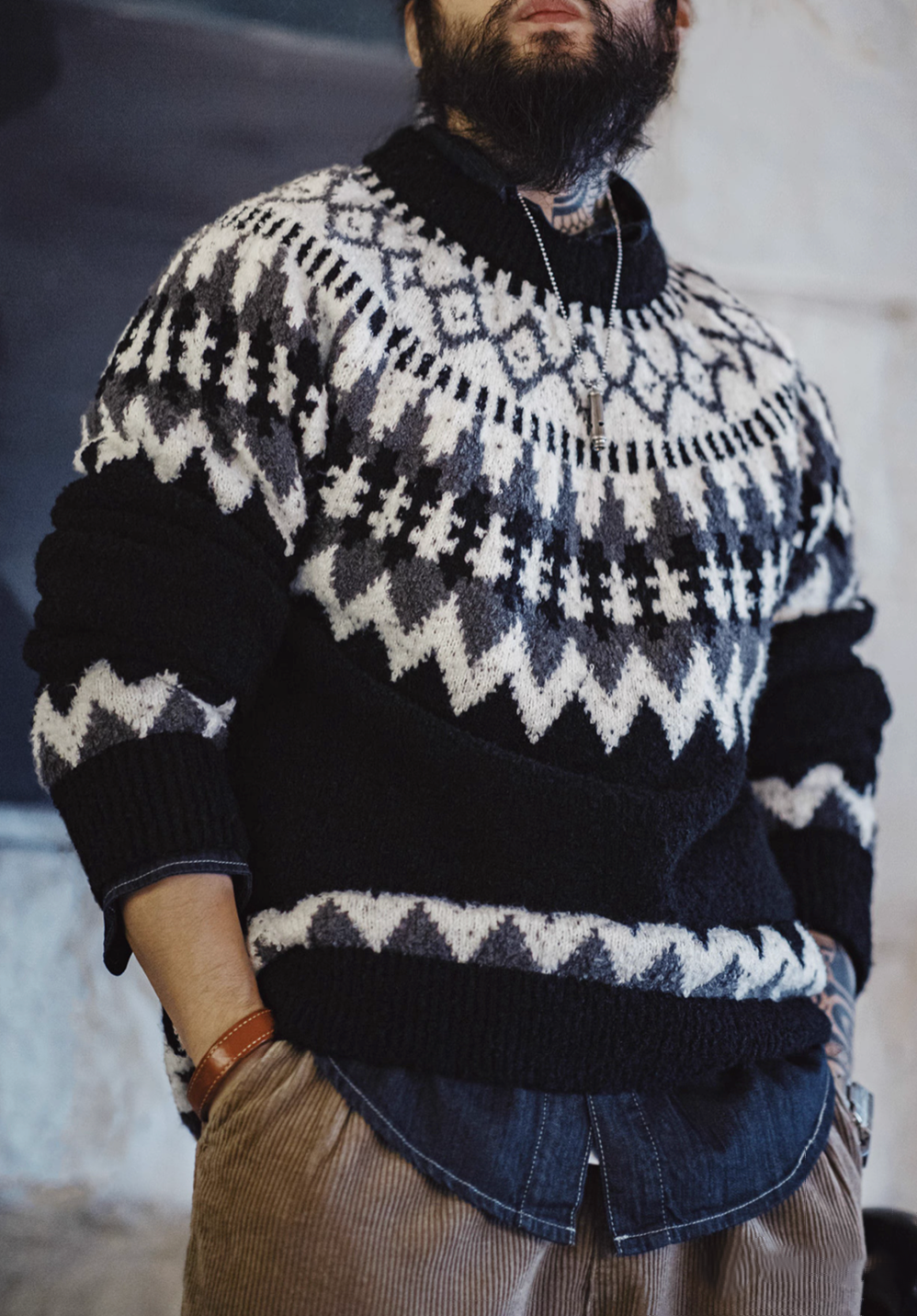 Angled front view of Glacier Peaks Knit Sweater Black White Gray highlighting geometric pattern textured knit and soft warm fabric