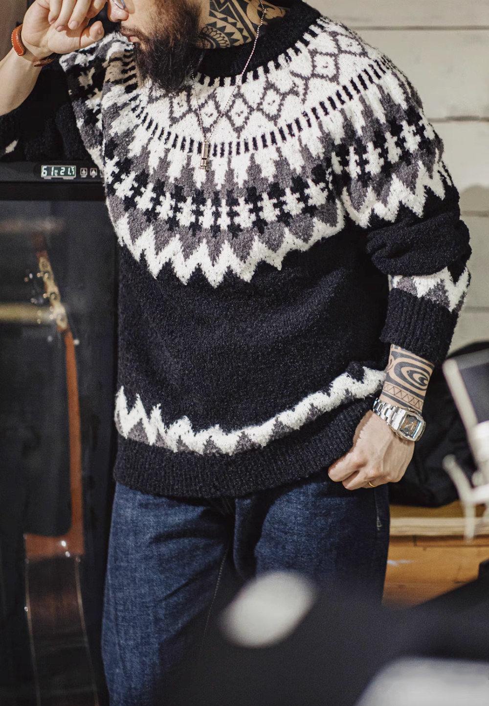 Man wearing Glacier Peaks Knit Sweater in Black White Gray showcasing classic Icelandic pattern crewneck design and relaxed straight fit styling
