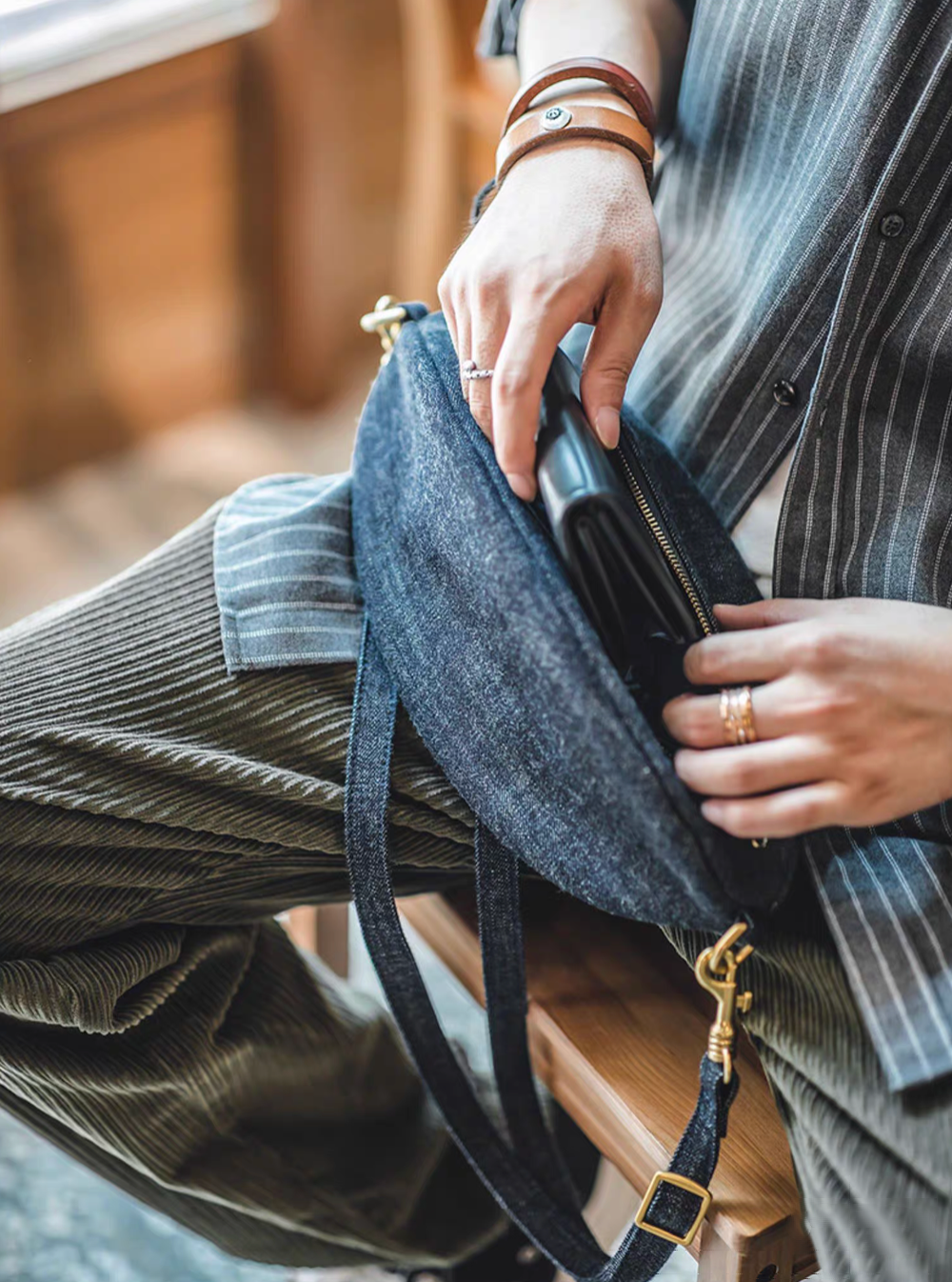 Goal-Line Denim Sling Crossbody Bag denim blue opened to reveal interior storage with secure zip closure ideal for carrying wallet phone and daily essentials