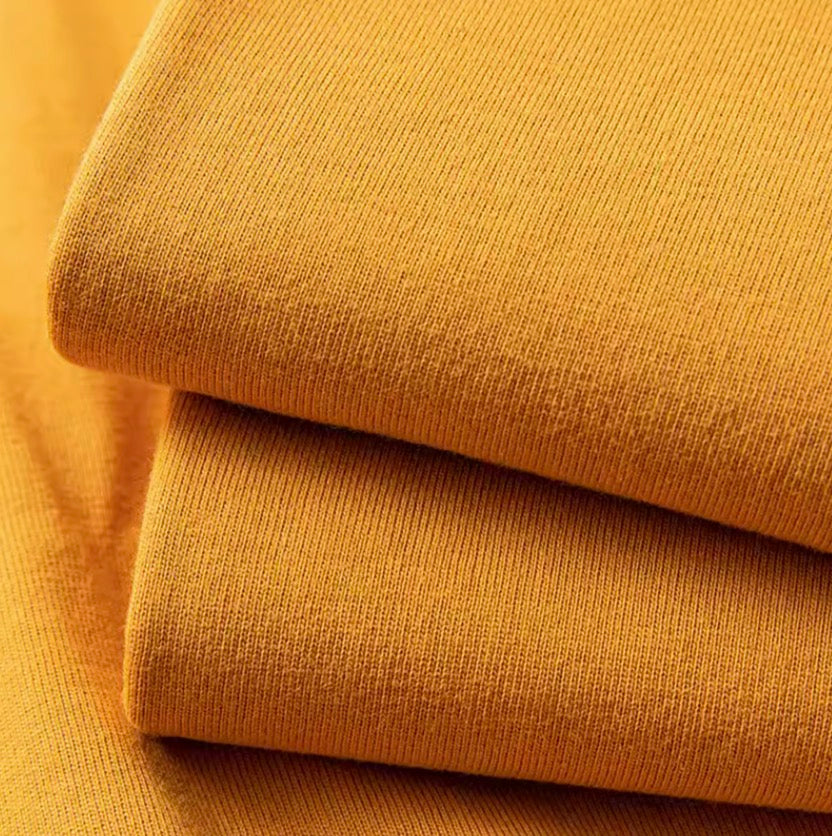 Golden Glow Tee mustard yellow color fabric texture close-up showing soft cotton material