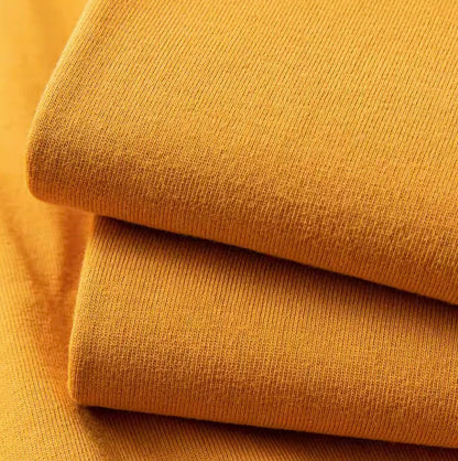 Golden Glow Tee mustard yellow color fabric texture close-up showing soft cotton material