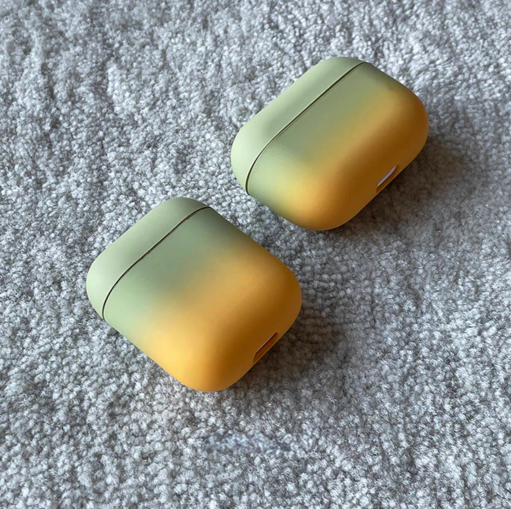 Two avocado green to yellow gradient AirPods cases displayed at different angles highlighting matte finish and smooth edges