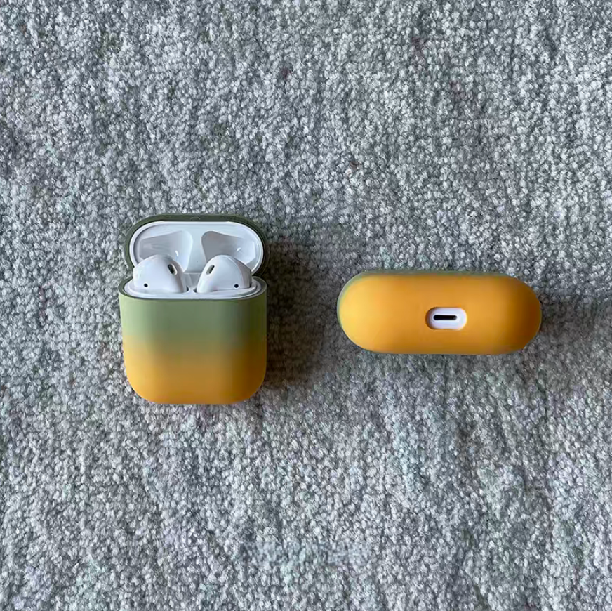 Avocado green gradient AirPods case opened with white earbuds inside and matching bottom case showing charging port