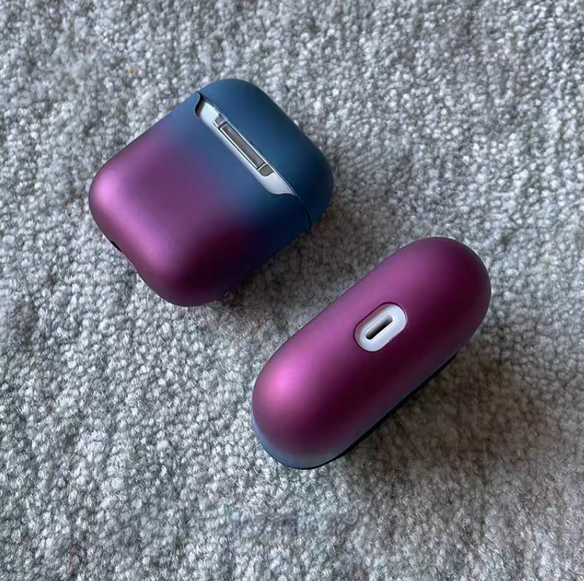 Peacock blue to purple gradient AirPods case showing bottom charging port and hinge detail with smooth finish