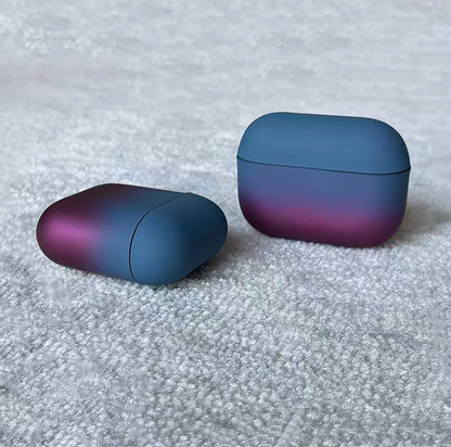 Peacock blue to purple gradient AirPods case showing closed case and separate top cover piece on textured carpet