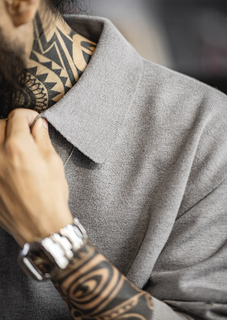 Close-up of open collar and knit texture on gray modal-blend polo sweater.