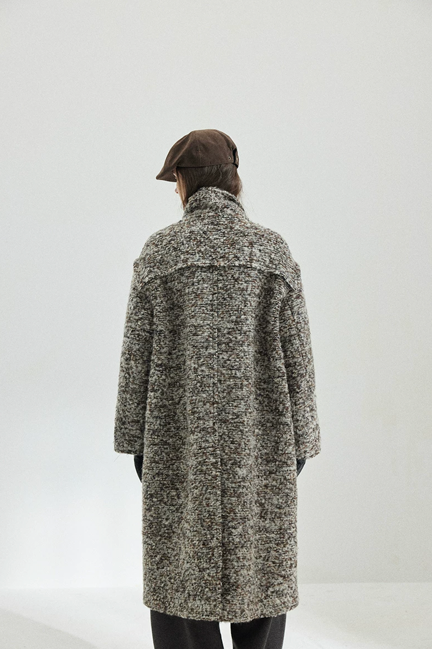 Back view of a Gray Marl long bouclé coat showing the raw-edge shoulder yoke and center back seam