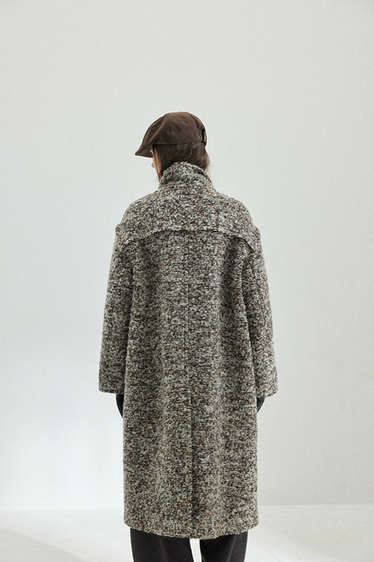 Back view of a Gray Marl long bouclé coat showing the raw-edge shoulder yoke and center back seam