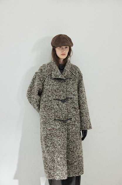 Gray Marl long bouclé wool coat fastened with faux-horn toggles, showing the stand collar and patch pockets