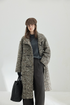 Gray Marl multicolor bouclé wool coat worn open, with the stand collar up and a front patch pocket