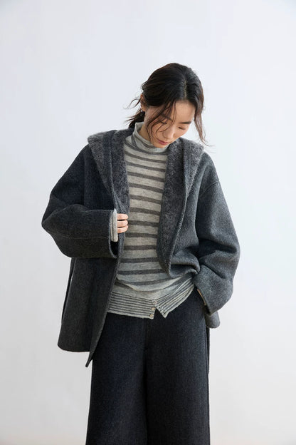 Grey striped turtleneck layered under a hooded wool cardigan