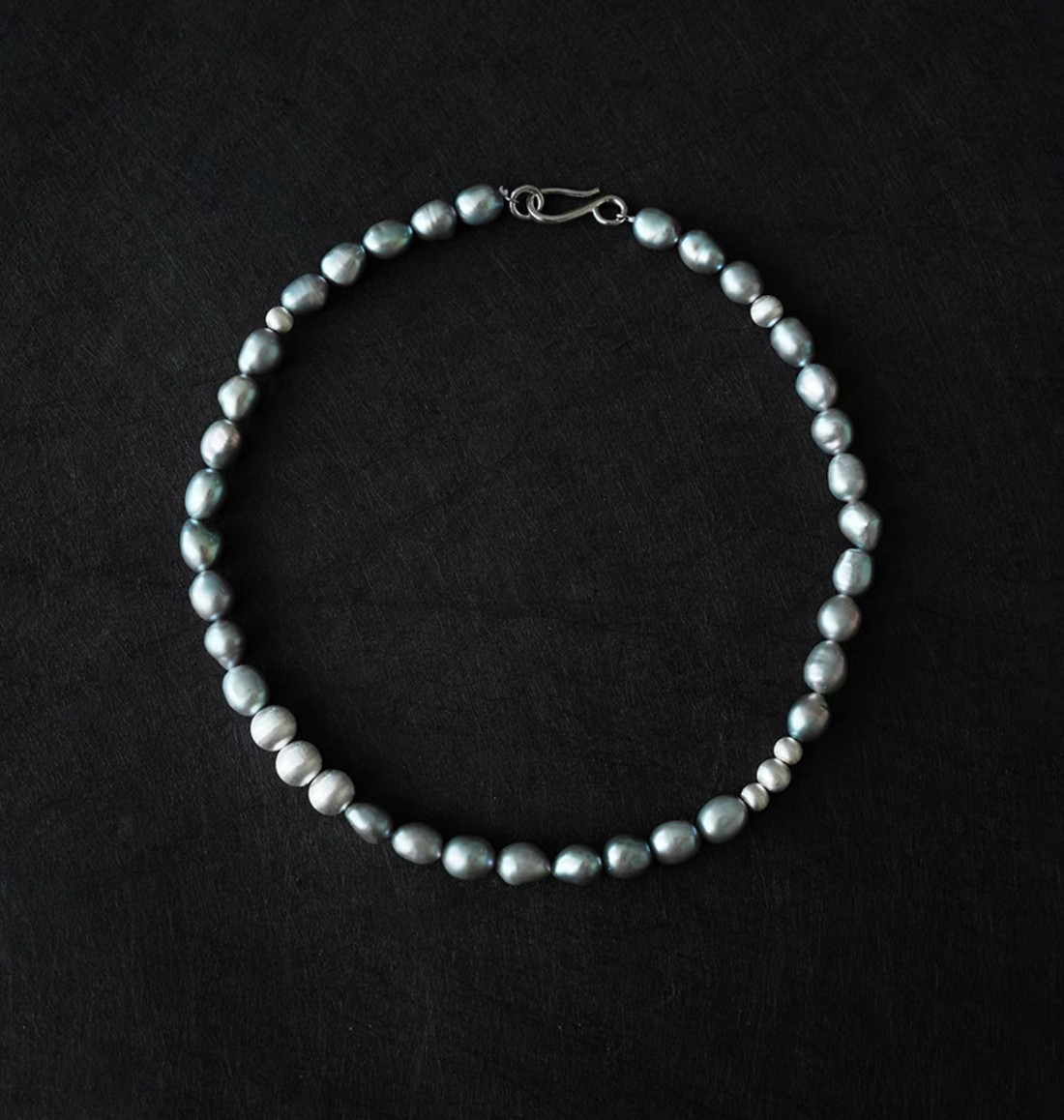 Grey Pearl Silver Necklace with natural freshwater grey pearls displayed on dark background full view
