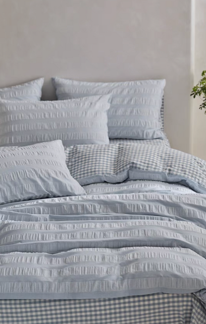 Light Blue Grid cotton bedding close-up with textured stripe duvet cover, pillow shams and checked sheet