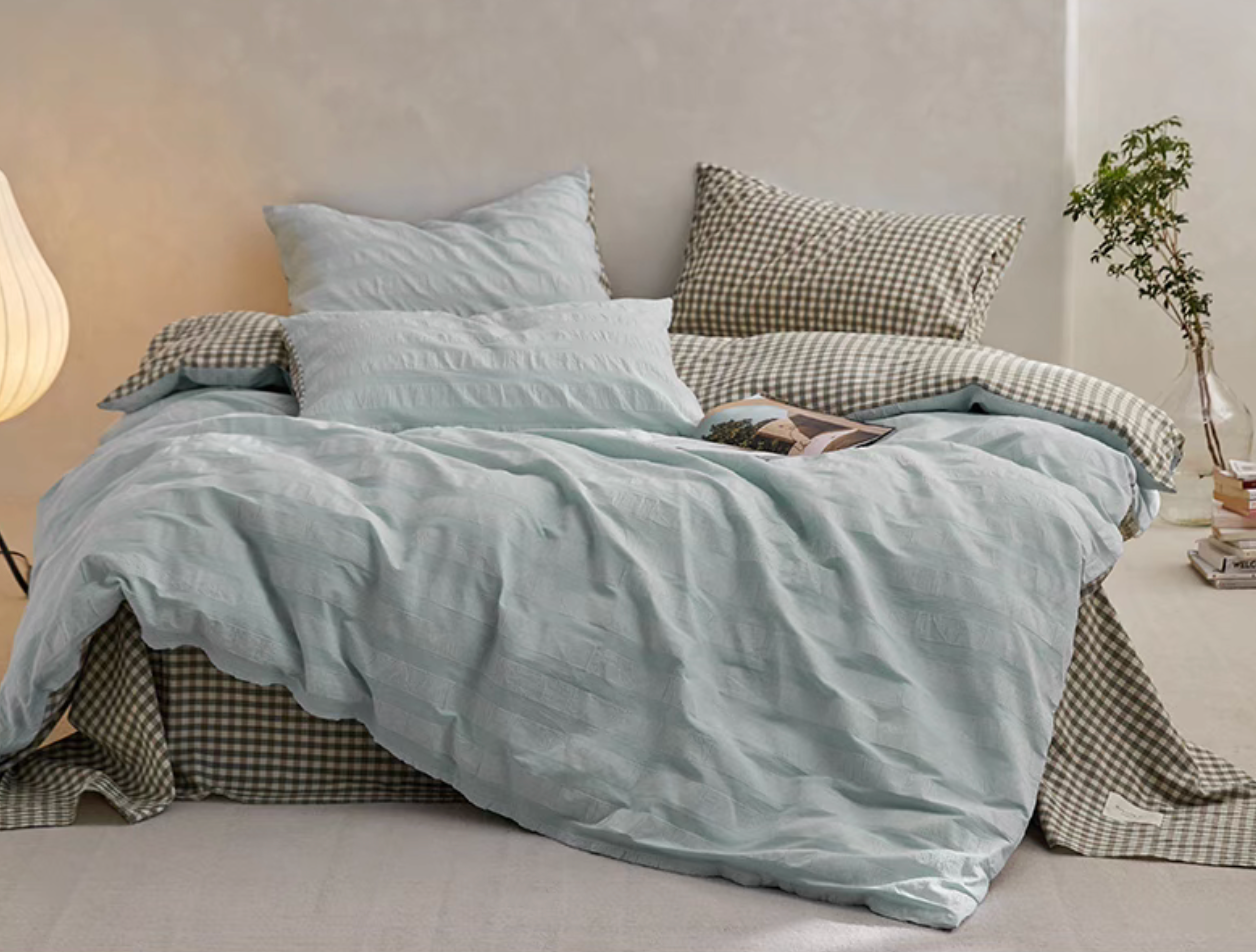 Light Green Grid cotton duvet, sheet and shams set with textured stripe duvet cover and checked bedding in bedroom scene
