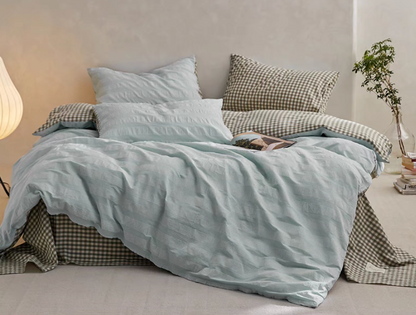 Light Green Grid cotton duvet, sheet and shams set with textured stripe duvet cover and checked bedding in bedroom scene