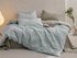 Light Green Grid cotton duvet, sheet and shams set with textured stripe duvet cover and checked bedding in bedroom scene