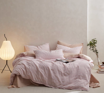 Pink Grid cotton duvet, sheet and shams set with textured stripe duvet cover and checked bedding in bedroom scene