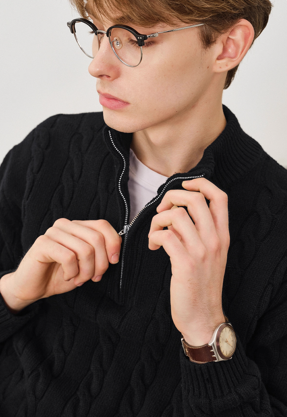 Close-up detail of half-zip mock neck cable knit sweater.