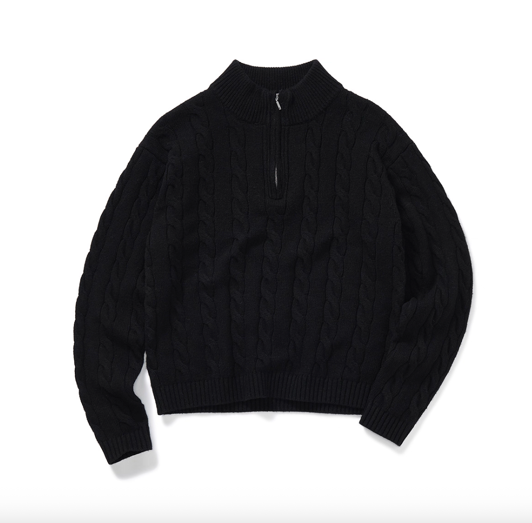 Half-zip black cable knit sweater flat lay with mock neck.