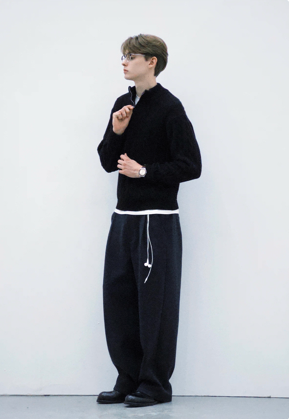 Men’s full-body look with half-zip black cable knit sweater.