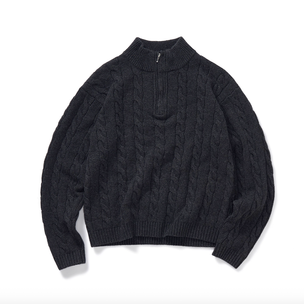 Flat lay of charcoal half-zip mock neck cable knit sweater.