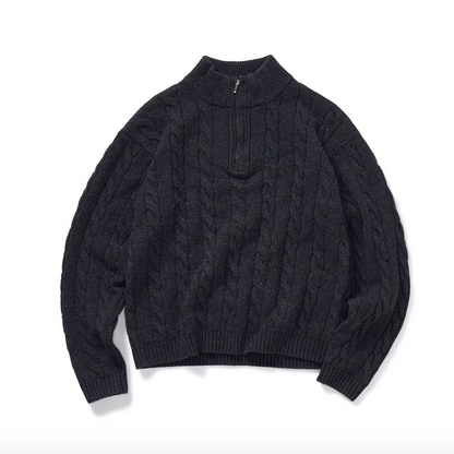 Flat lay of charcoal half-zip mock neck cable knit sweater.