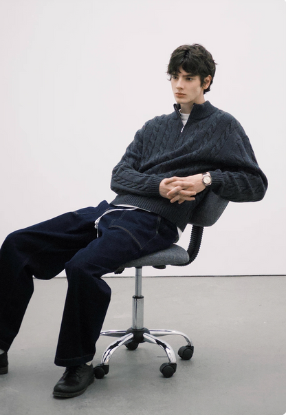 Charcoal half-zip cable knit sweater styled for casual winter look.