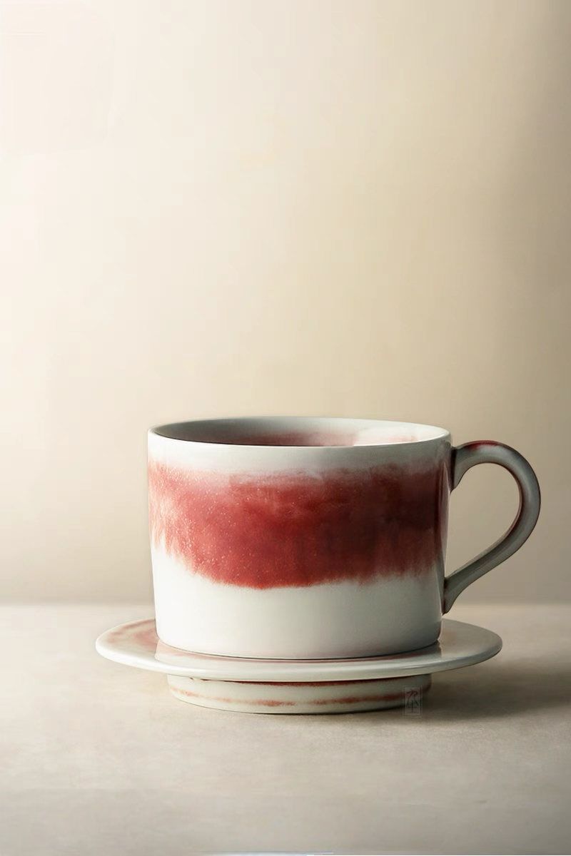 Style 2 handcrafted crimson glaze ceramic cup and saucer front view with deeper red band and taller cup shape