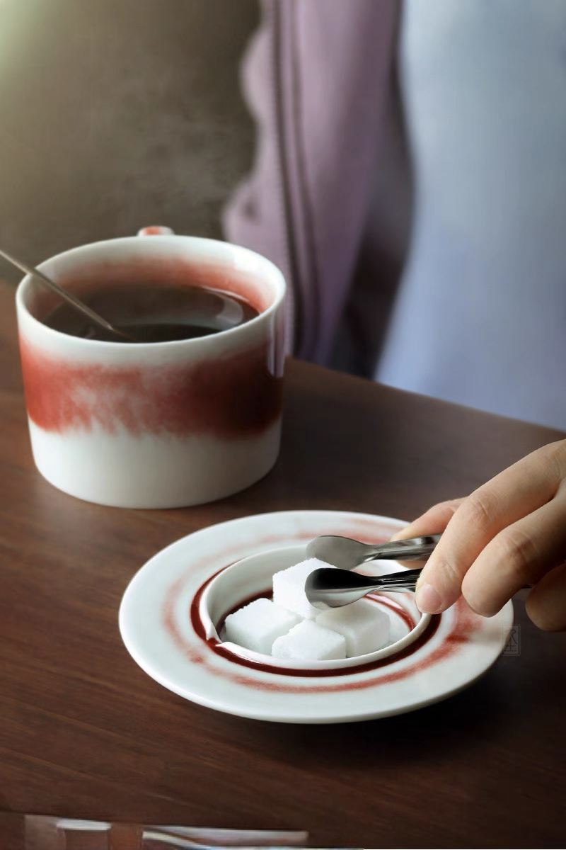 Style 2 ceramic saucer used for sugar cubes with matching crimson glaze showing functional tableware detail