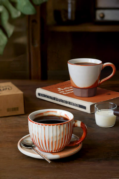 Style 1 handcrafted ceramic ridged cup and saucer set in off-white and orange shown in clean front product view