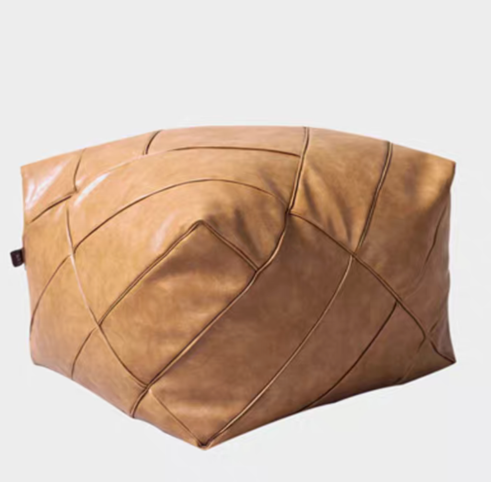Khaki handwoven leather cube pouf with soft structure and stitched detailing shown in angled single product view