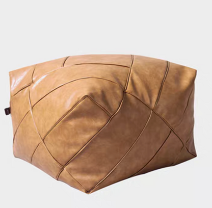 Khaki handwoven leather cube pouf with soft structure and stitched detailing shown in angled single product view