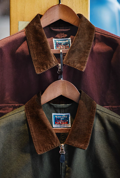 The green and burgundy Hardman Detroit 90s Workwear Jackets hanging side by side, showing their distinct corduroy collars.