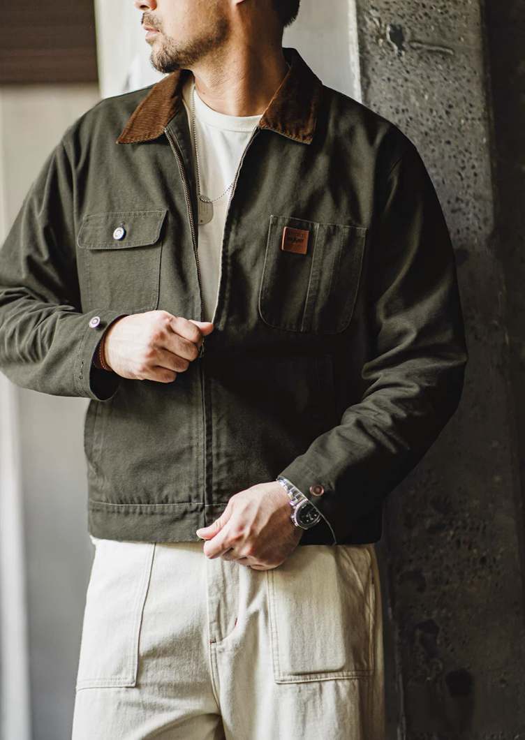 Model showing off the side details of the green Hardman Detroit 90s Workwear Jacket, including adjustable side seams.