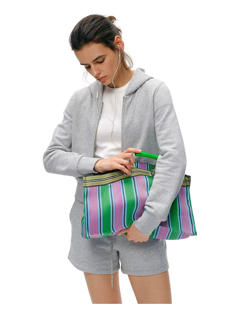 Waist-up front view of Heather Gray cotton zip hoodie with ribbed cuffs