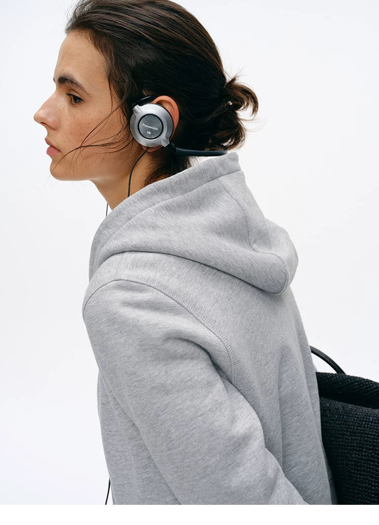 Side profile of Heather Gray zip hoodie showing hood and French terry texture