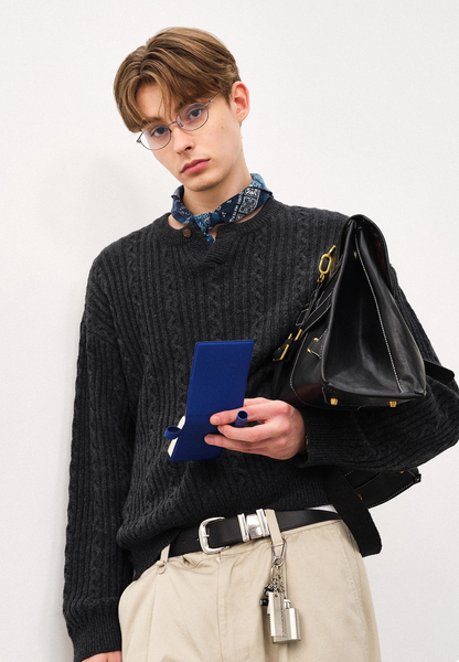 Male model wearing charcoal Henley cable-knit wool sweater with bag