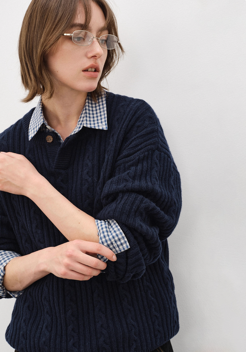 Female model closeup wearing navy Henley wool blend cable sweater