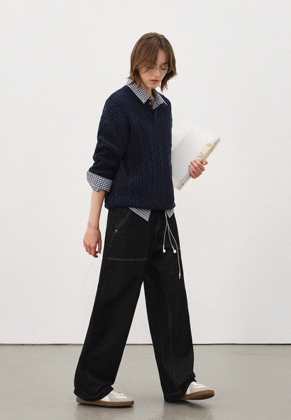 Women’s navy cable-knit Henley sweater paired with black denim and sneakers, relaxed fall winter fashion outfit