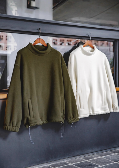 Olive Green and Cream White Fleece Sweatshirts hanging on wooden hangers