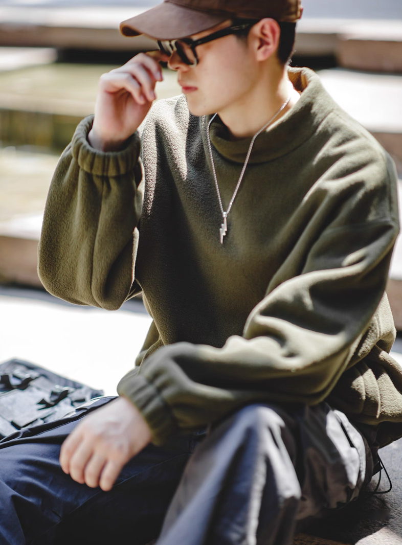 Olive Green Mock Neck Sweatshirt street-style look, model seated casually