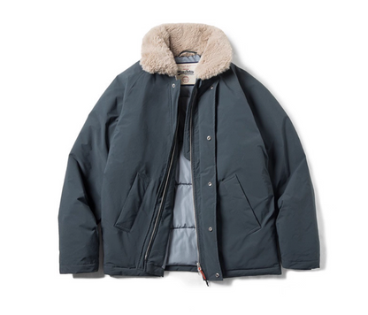 Slate blue bomber jacket with detachable faux-fur collar laid flat.
