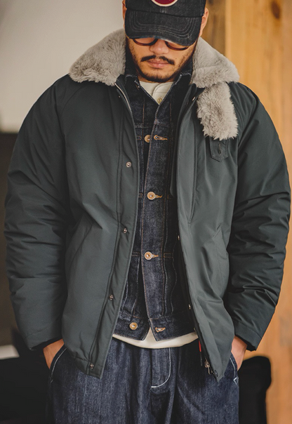 Model wearing bomber jacket layered over denim jacket and white tee.