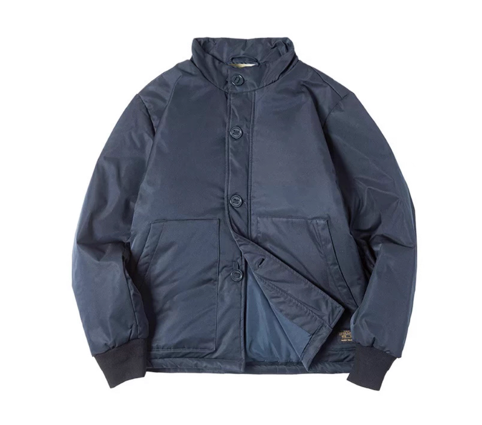 Navy stand-collar padded jacket laid flat with rib cuffs.