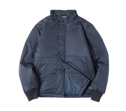 Navy stand-collar padded jacket laid flat with rib cuffs.
