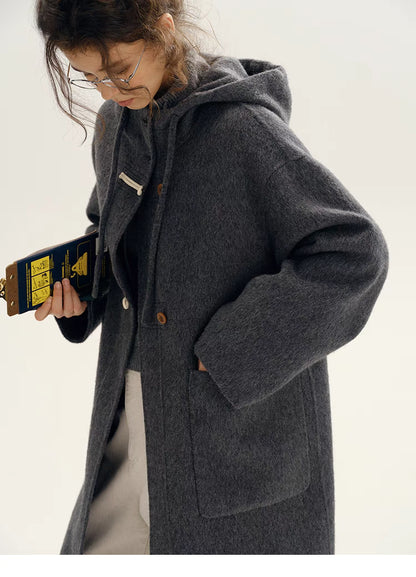 Close-up of Highland Wool Toggle Coat in dark gray highlighting toggle closures, front patch pocket, hood detail, and soft wool texture