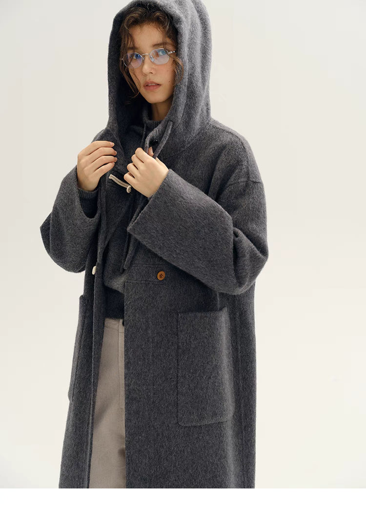 Front view of Highland Wool Toggle Coat in dark gray showing hooded design, toggle fastening, relaxed H-line silhouette, and mid-length structure